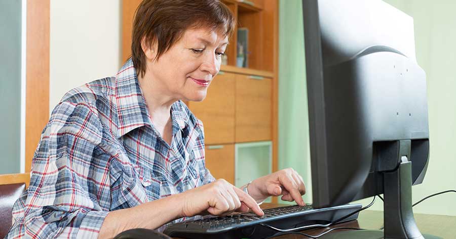 Elderly woman working at computer