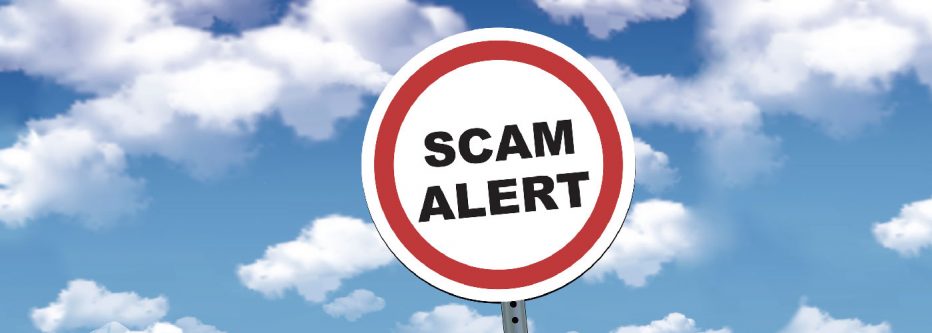 street sign reads Scam Alert