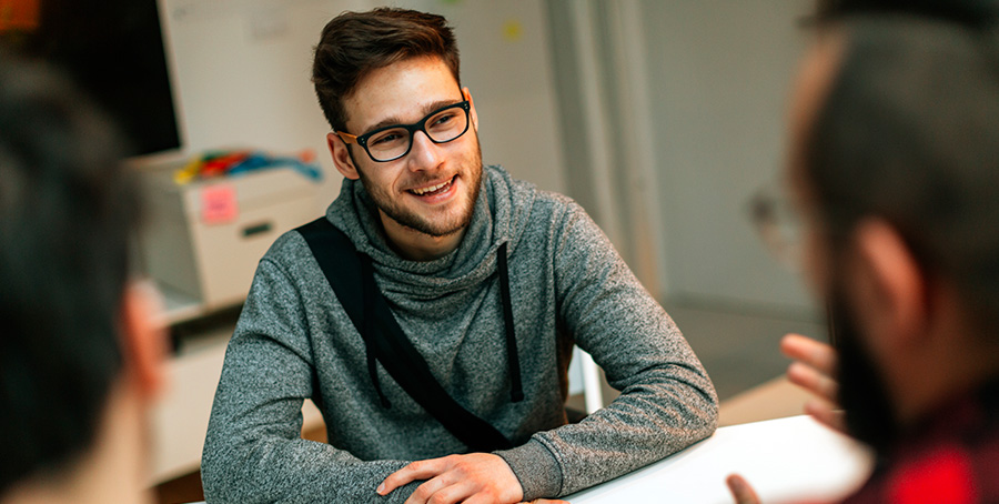 Image of a young man at a meeting